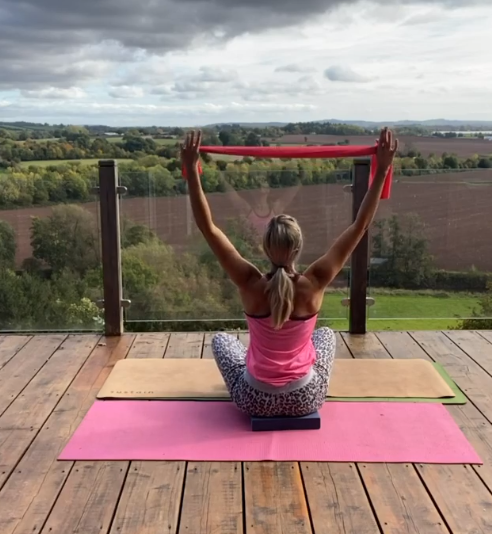 Stretching with a band, seated position